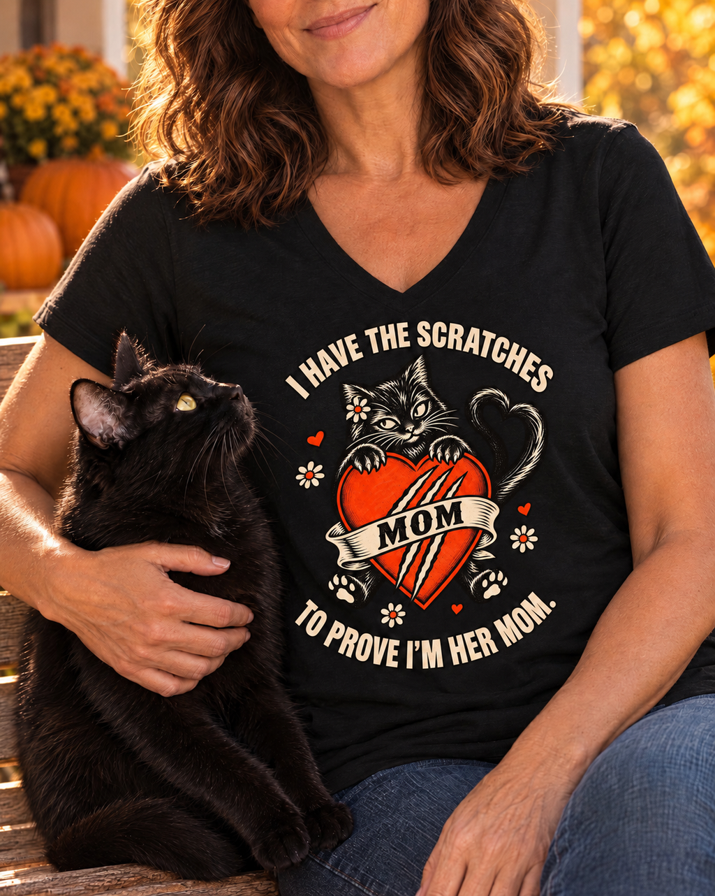 Plain sleeves — Close-up of the I Have the Scratches Cat Mom V-neck tee worn by a woman holding her black cat