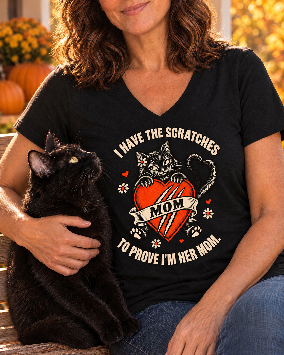 Plain sleeves — Close-up of the I Have the Scratches Cat Mom V-neck tee worn by a woman holding her black cat