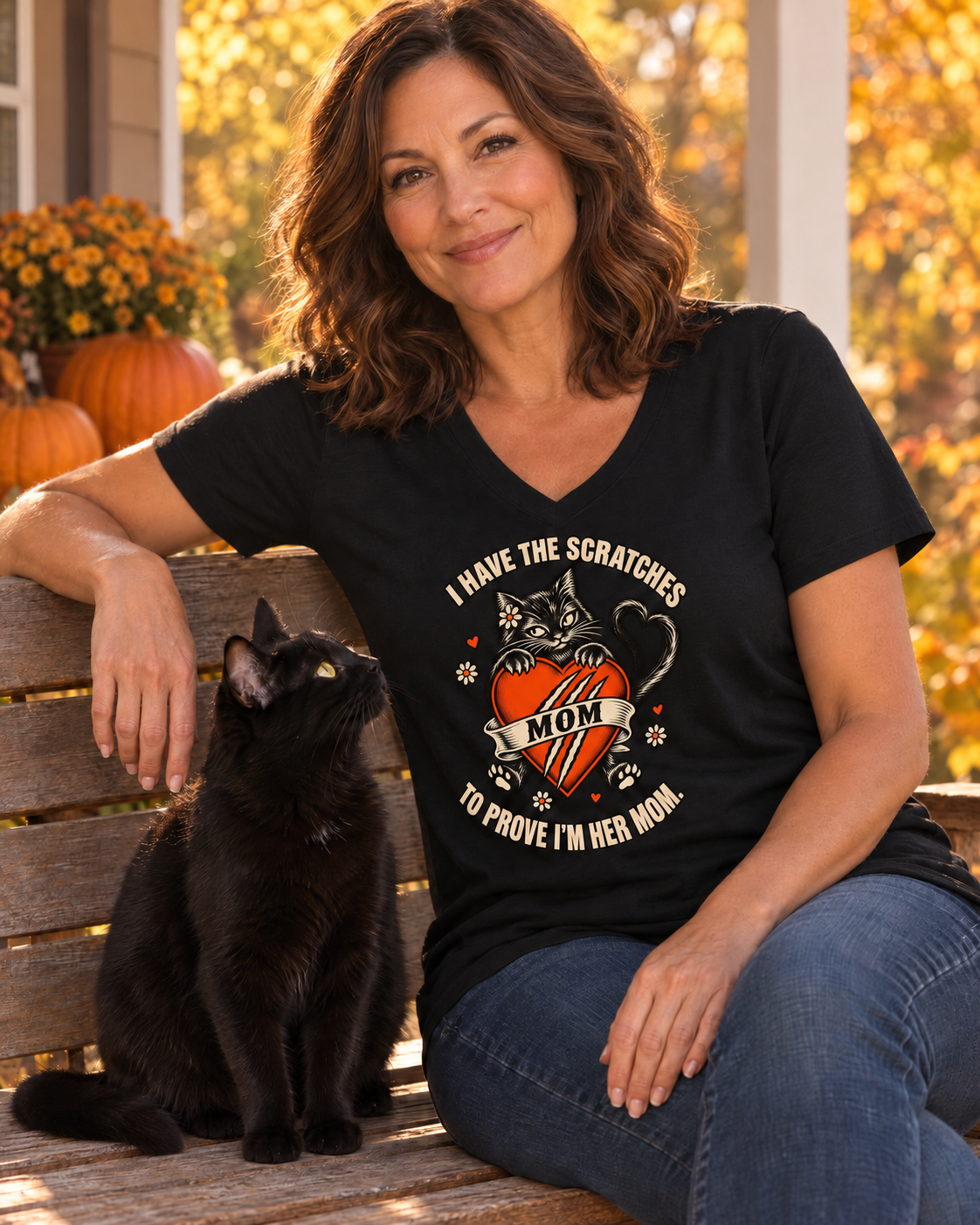 Plain sleeves — Woman in a black Little Monsters Cat Mom V-neck tee sitting on a porch bench next to her black cat