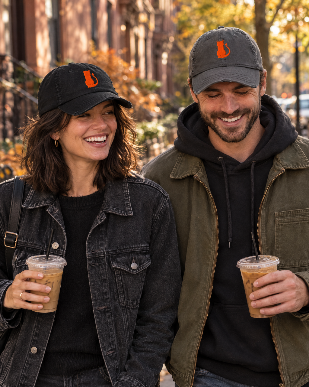 Couple walking in New York wearing the black and charcoal grey Little Monsters devil cat hats