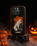 Little Monsters Halloween graveyard cat iPhone case standing on a black stone plinth with fog and glowing jack-o'-lanterns