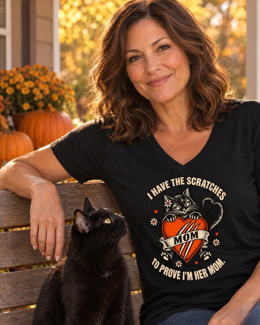 I Have the Scratches V-neck on a porch bench with a black cat