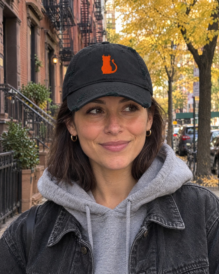 Devil Cat embroidered dad hat on a city street