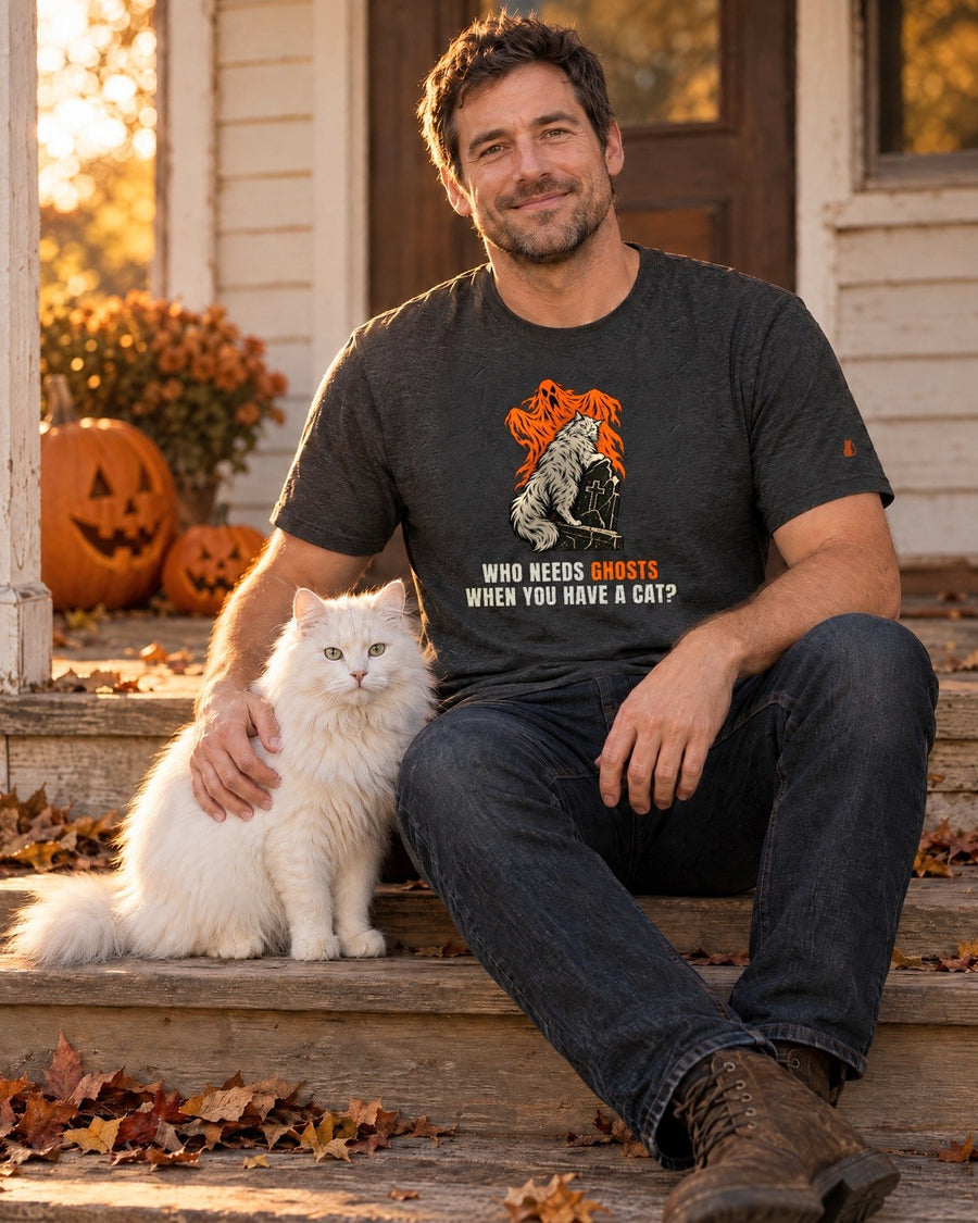 Who Needs Ghosts tee worn on a porch with a white cat