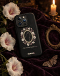 Scratched With Love iPhone case on dark velvet with white moonflowers, a moth and an antique gold frame